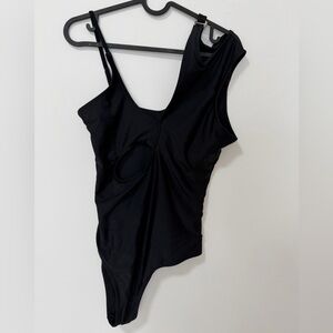 black one-piece swimsuit with cutouts and an asymmetrical neckline